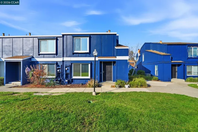 a view of a house with a yard and sitting area