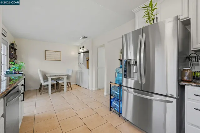 a kitchen with stainless steel appliances a refrigerator and a table
