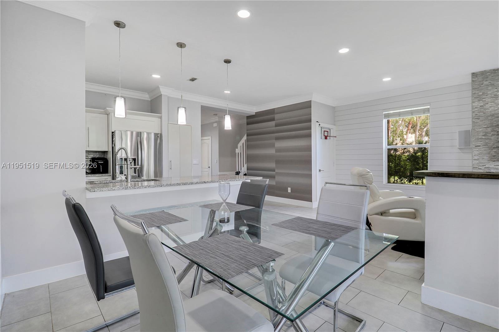 6047 Seminole Gardens Circle Riviera Beach, FL 33418 - Photo 12 of 40 a view of a a dining room with furniture window and wooden floor