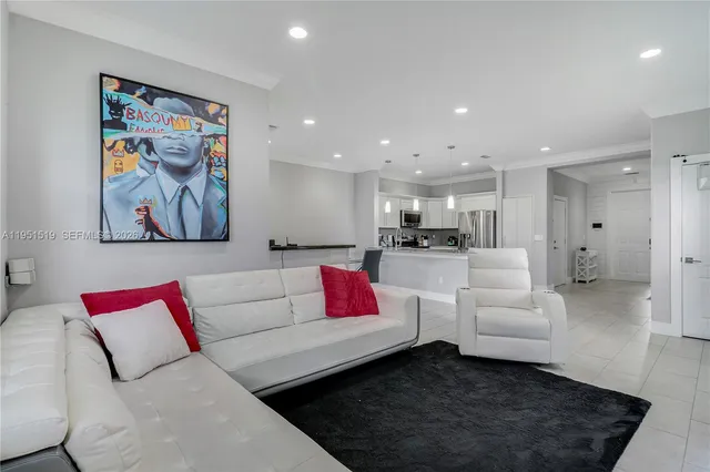 a living room with furniture and kitchen view