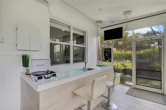 a living room with a flat screen tv and a floor to ceiling window