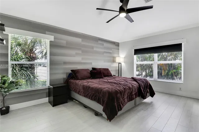 a bedroom with a bed and large window