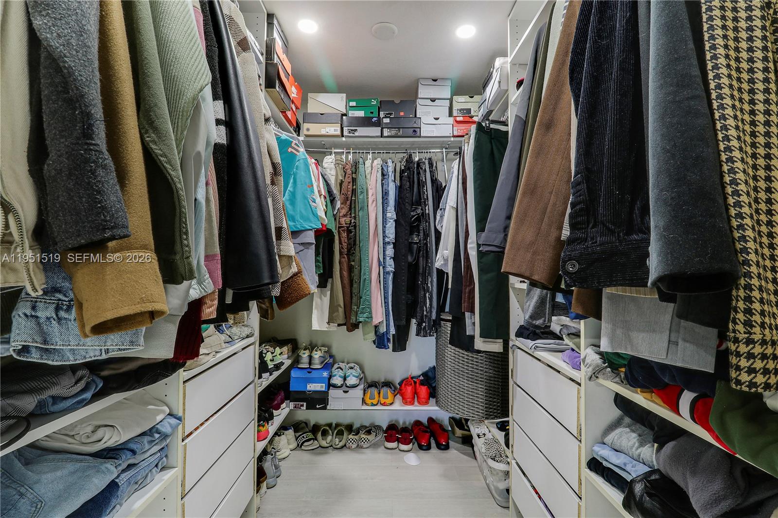 6047 Seminole Gardens Circle Riviera Beach, FL 33418 - Photo 24 of 40 a view of walk in closet with clothes and shoes