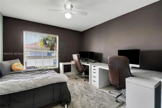 a bedroom with a bed and a desk