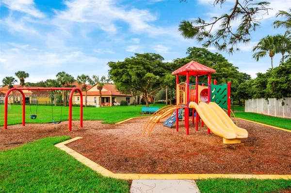 a view of a park with swings and slides