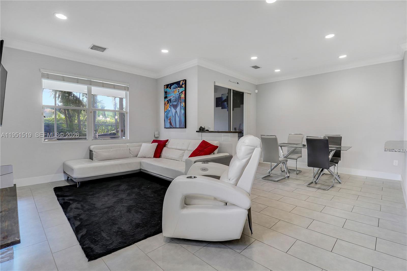 6047 Seminole Gardens Circle Riviera Beach, FL 33418 - Photo 4 of 40 a living room with furniture and a window