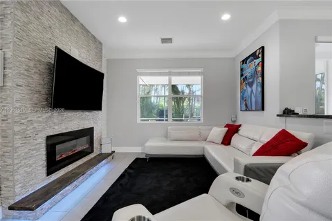 a living room with fireplace furniture and a flat screen tv