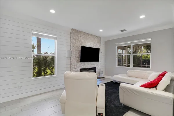 a living room with furniture and a flat screen tv