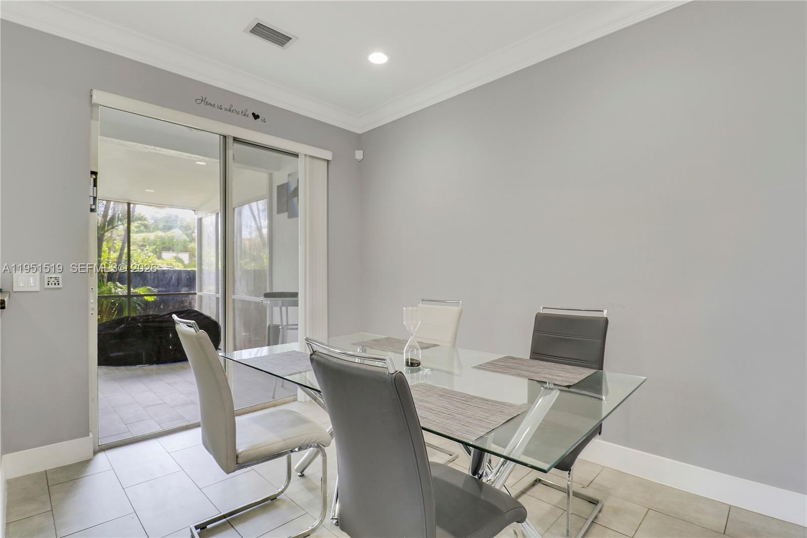 6047 Seminole Gardens Circle Riviera Beach, FL 33418 - Photo 8 of 40 a view of a workspace with furniture and a potted plant