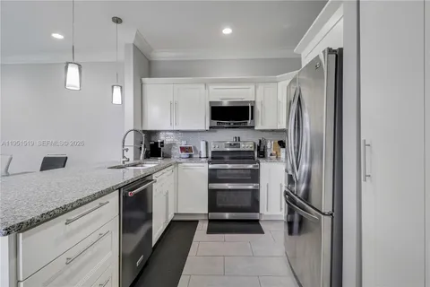 a kitchen with a refrigerator and a sink