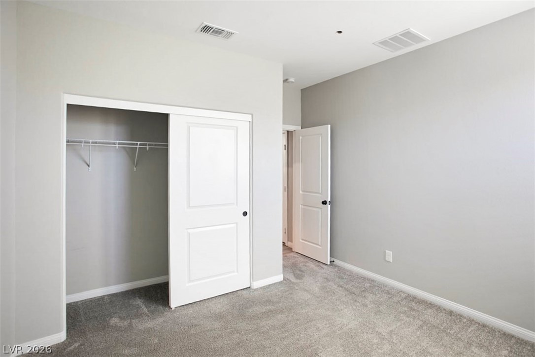 2865 Mincio Street Henderson, NV 89044 - Photo 4 of 33 Unfurnished bedroom featuring carpet and a closet
