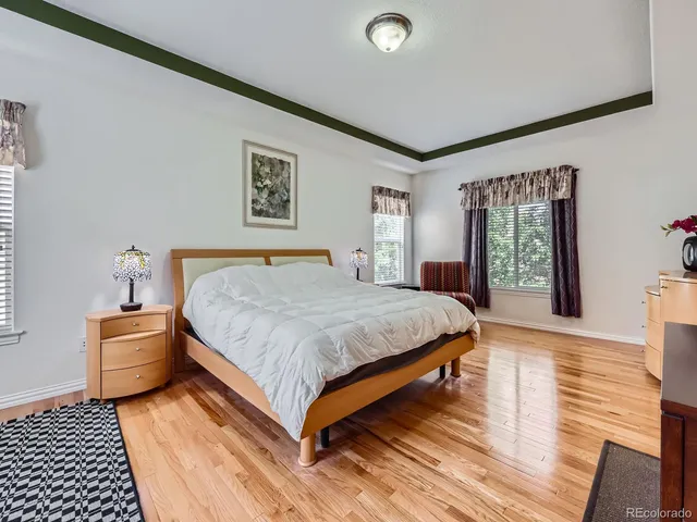 a bedroom with a bed lamp and a window