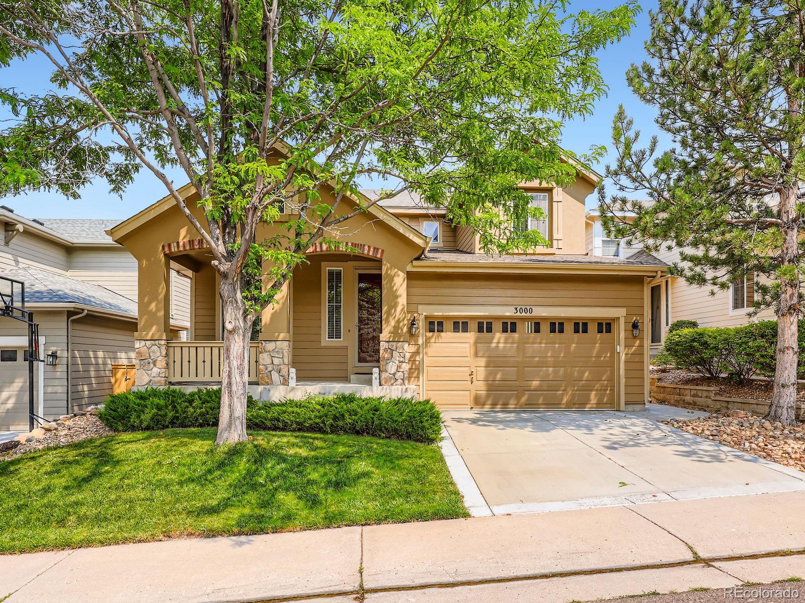 3000 Fox Sedge Lane Highlands Ranch, CO 80126 - Photo 21 of 33 a front view of a house with a yard and a garage