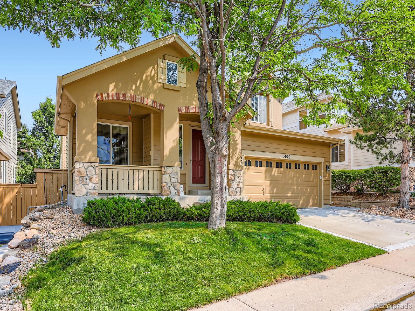 3000 Fox Sedge Lane Highlands Ranch, CO 80126 - Photo 22 of 33 a view of a house with brick walls and a yard with plants and large trees