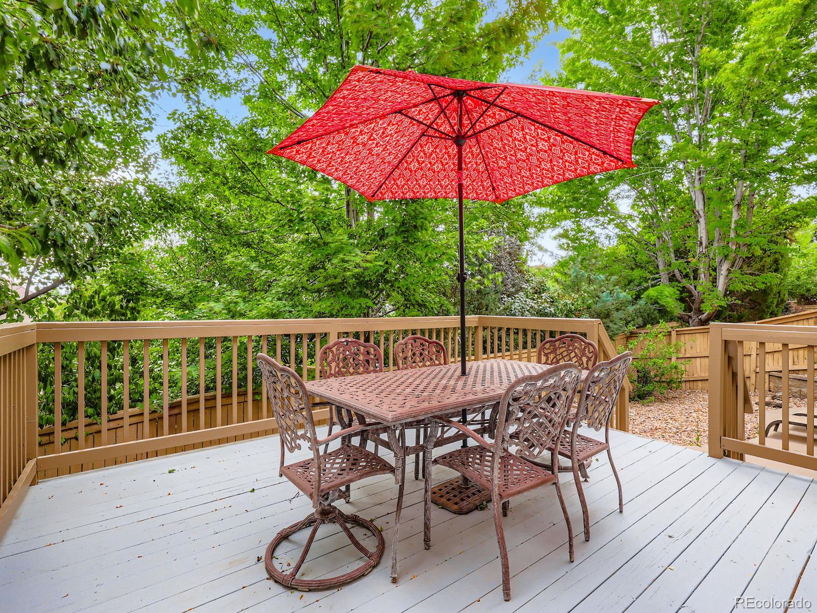 3000 Fox Sedge Lane Highlands Ranch, CO 80126 - Photo 25 of 33 a patio with wooden floor a yard a table and chairs