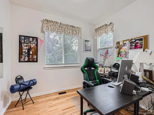a view of a workspace with furniture and a window