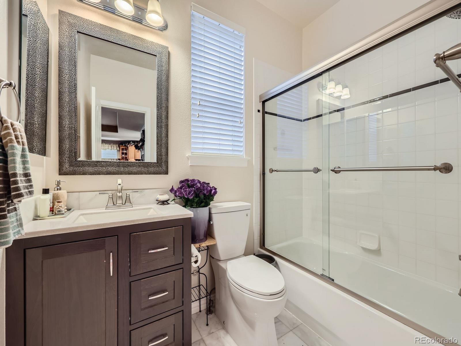 3000 Fox Sedge Lane Highlands Ranch, CO 80126 - Photo 10 of 33 a bathroom with a sink toilet and shower