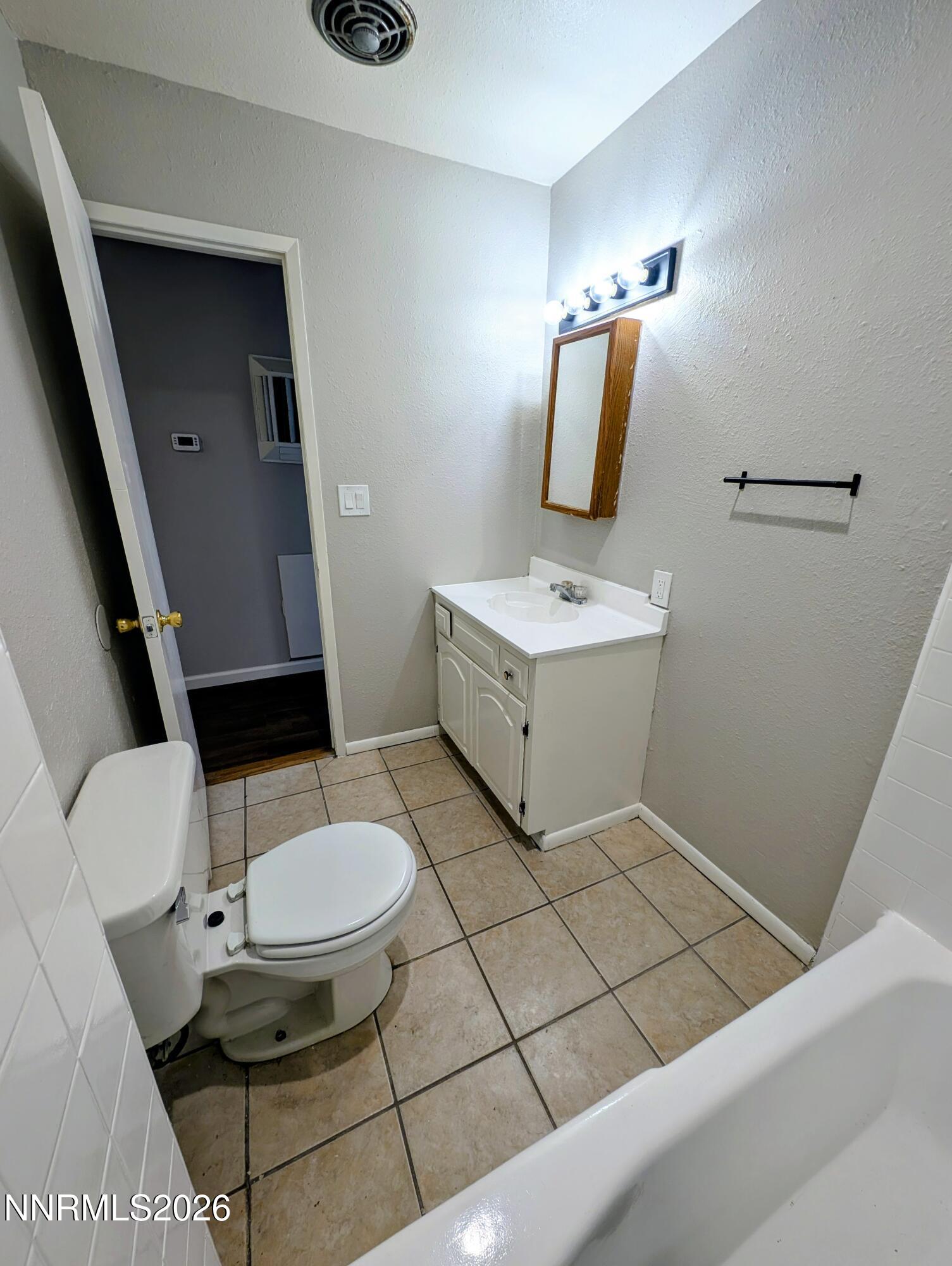 367 Connelly Street Hawthorne, NV 89415 - Photo 15 of 32 a bathroom with a toilet a sink and mirror