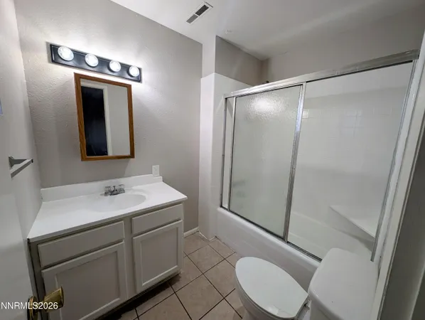an empty room with white walls and tiles