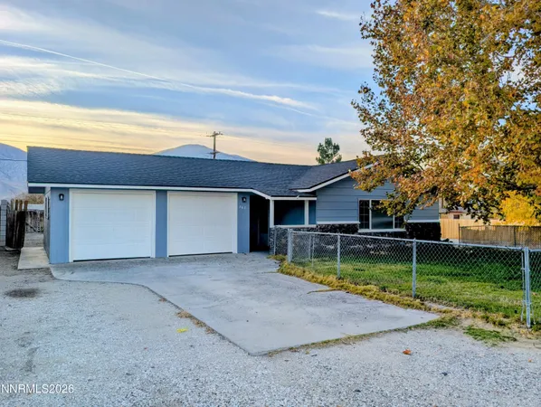 a view of a house with a yard garage and a fountain