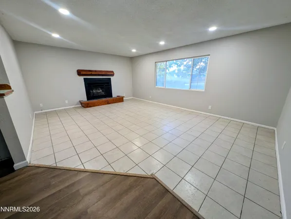 a view of an empty room and a window