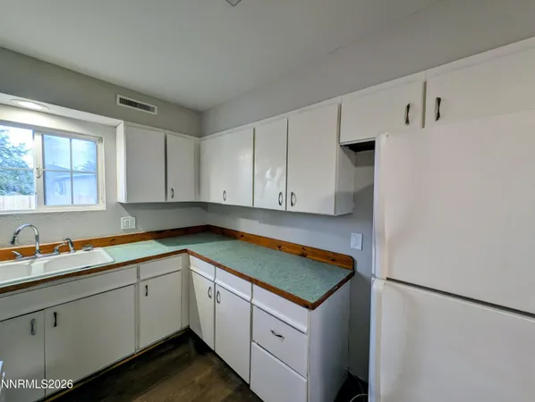 a utility room with cabinets washer and dryer