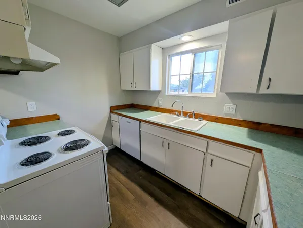 a kitchen with a stove and a refrigerator