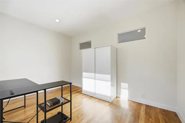 a spacious bathroom with a tub sink and a mirror