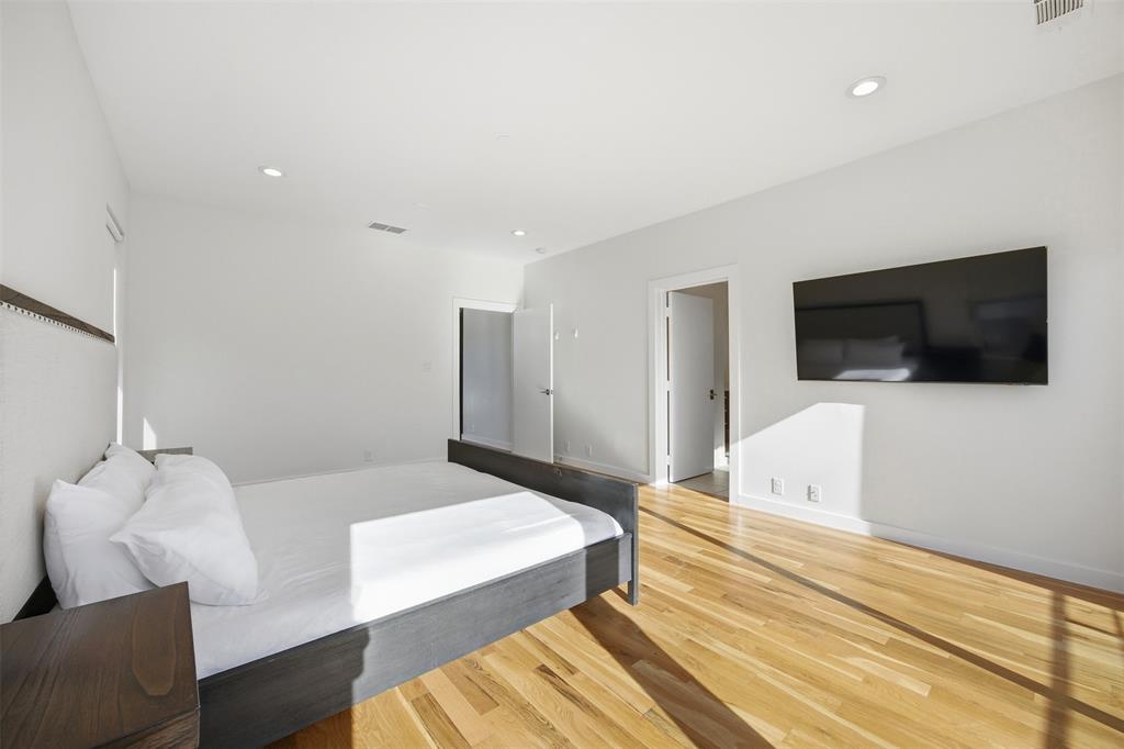 5326 Manett Street Dallas, TX 75206 - Photo 16 of 36 a bedroom with a bed and a flat screen tv