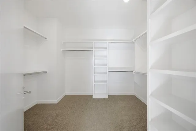 a spacious bedroom with a bed and a window