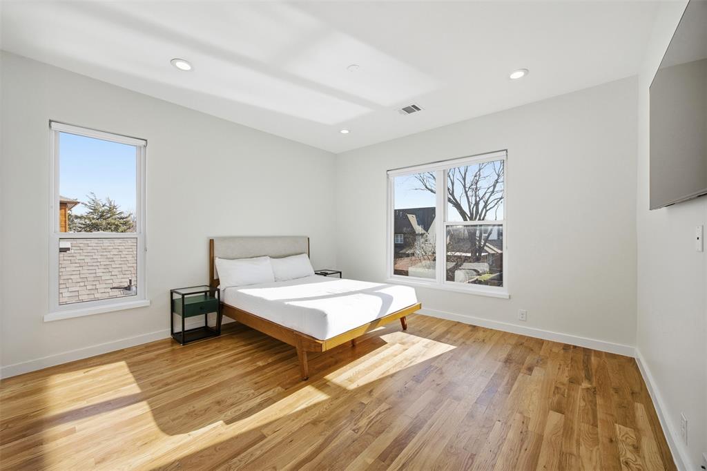 5326 Manett Street Dallas, TX 75206 - Photo 18 of 36 a spacious bedroom with a bed and a window
