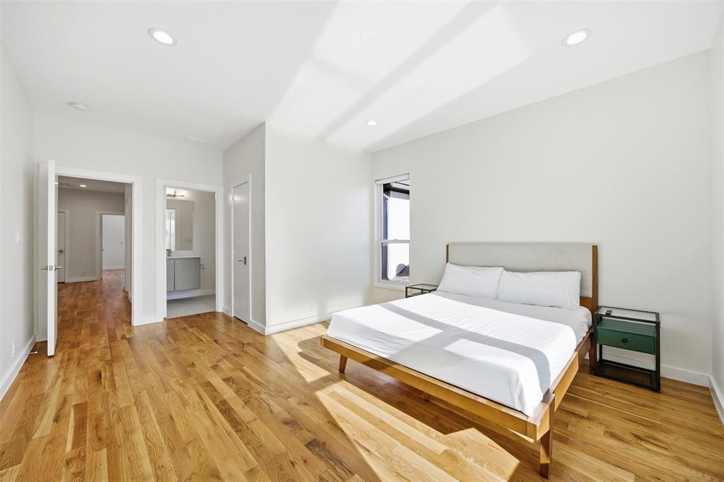 5326 Manett Street Dallas, TX 75206 - Photo 19 of 36 a bedroom with a bed and a table