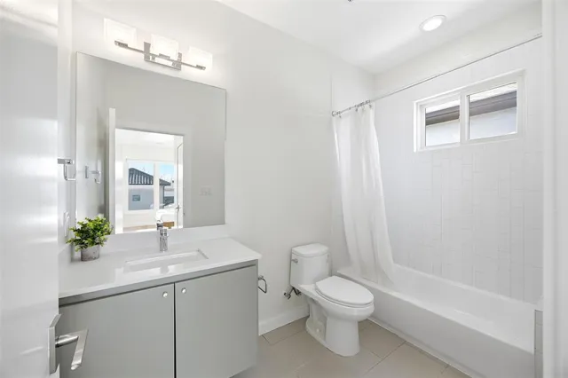 an empty room with a kitchen and entryway