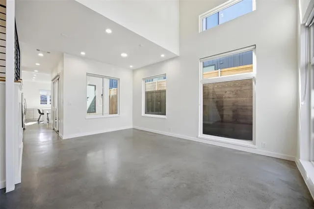 a spacious bedroom with a bed and a large window