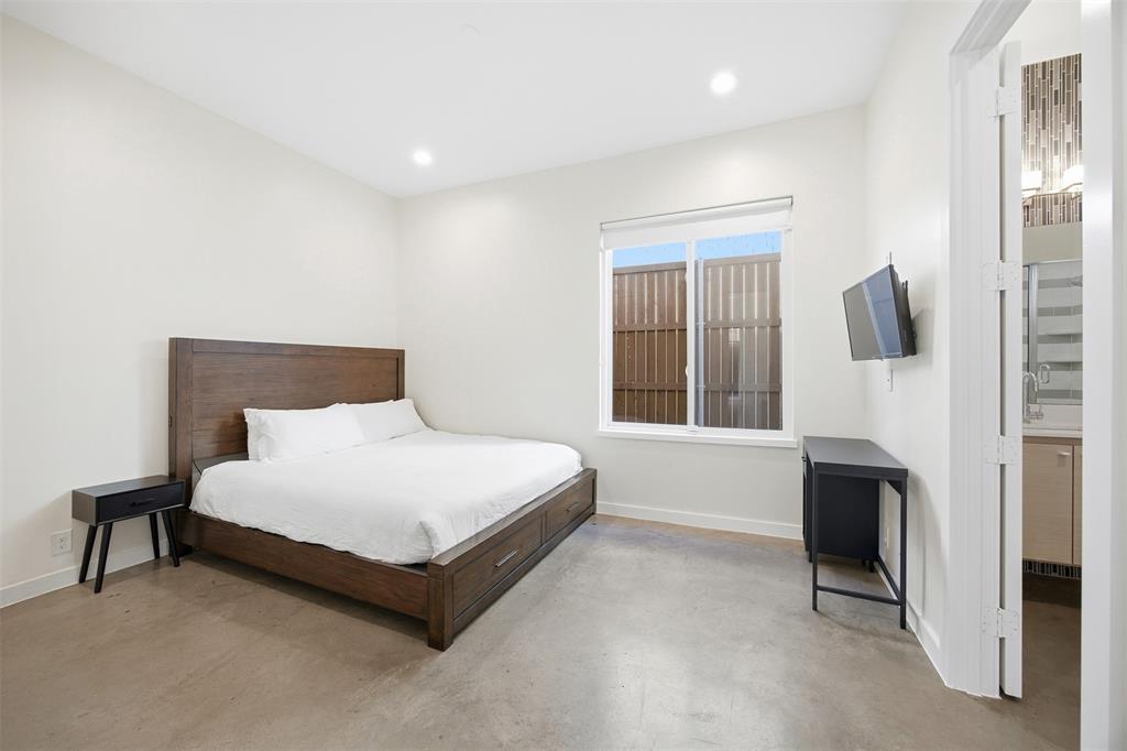5326 Manett Street Dallas, TX 75206 - Photo 23 of 36 a spacious bedroom with a bed and a large window