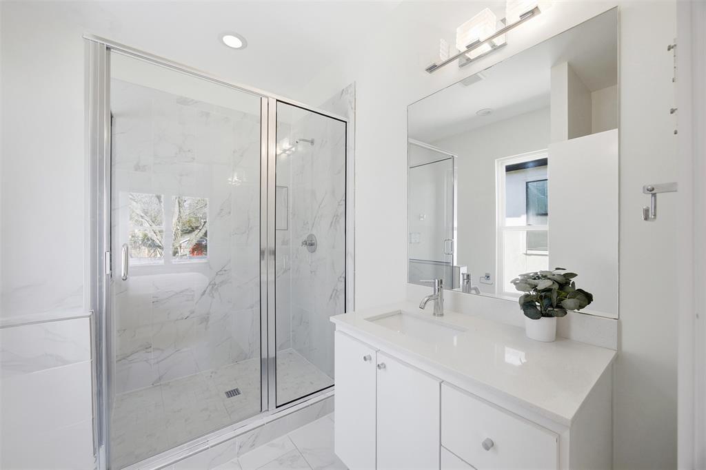 5326 Manett Street Dallas, TX 75206 - Photo 26 of 36 a bathroom with a shower sink and mirror