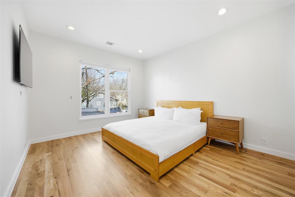 5326 Manett Street Dallas, TX 75206 - Photo 27 of 36 a large bed sitting in a room next to a window