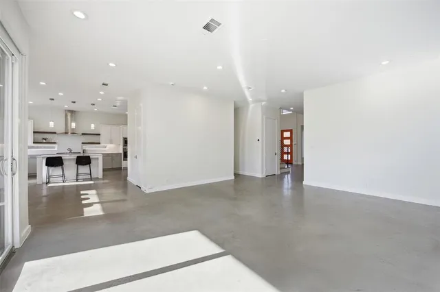 a view of empty room with wooden floor and fireplace