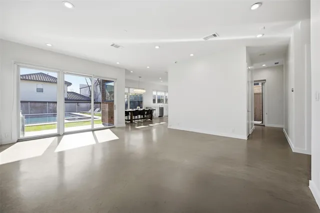 a large white kitchen with a large window