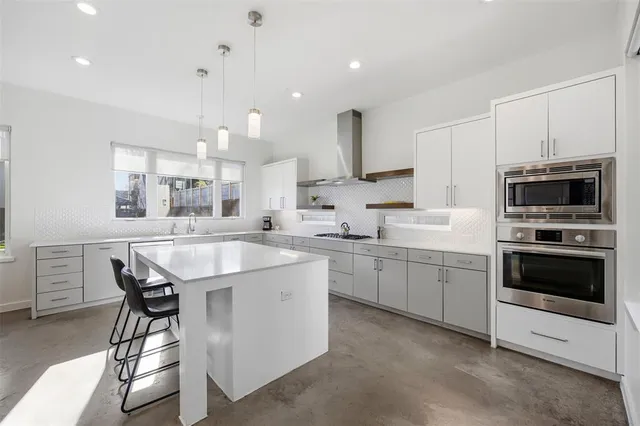 a large kitchen with lots of counter space and windows