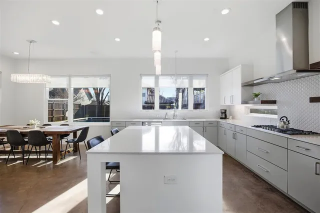 a room with stainless steel appliances kitchen island granite countertop furniture and a view of living room