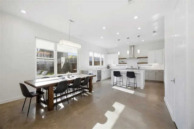 a kitchen with kitchen island granite countertop a counter space a sink appliances and cabinets