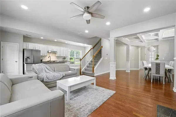 a living room with furniture and kitchen view
