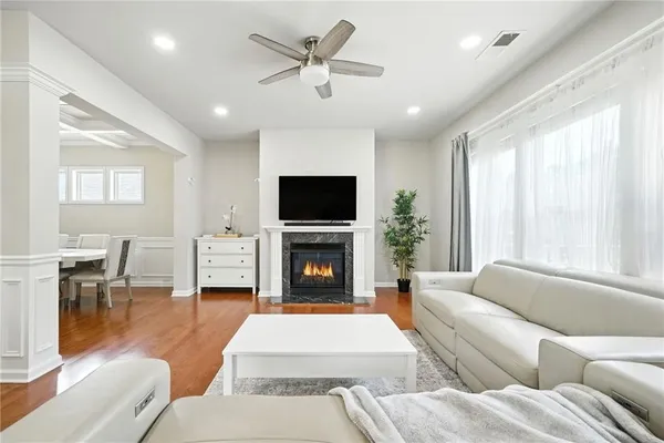 a living room with furniture a fireplace and a flat screen tv