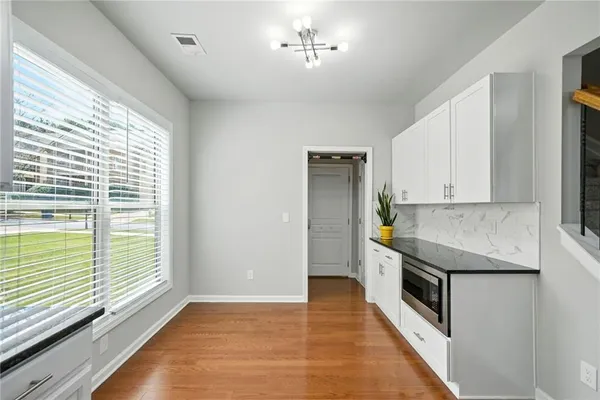 a kitchen with granite countertop a stove and a sink