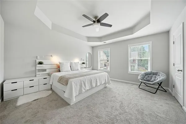 a spacious bedroom with a bed and a window