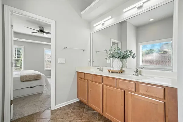 a en suite bathroom with a double vanity sink and a mirror