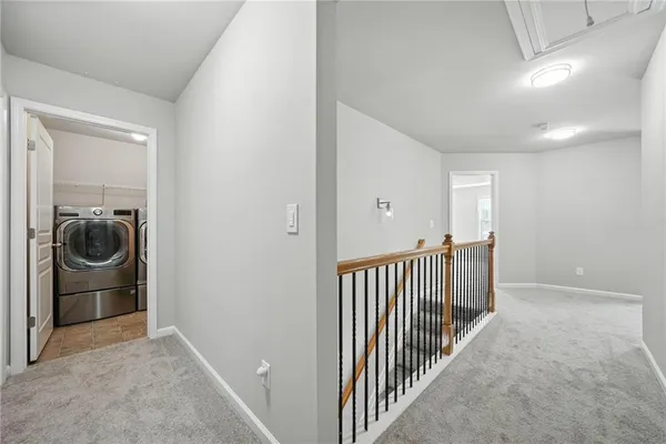 a view of a hallway to a livingroom and a couch