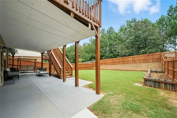 a view of a porch with furniture and a yard