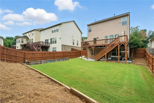 a view of backyard of house and deck